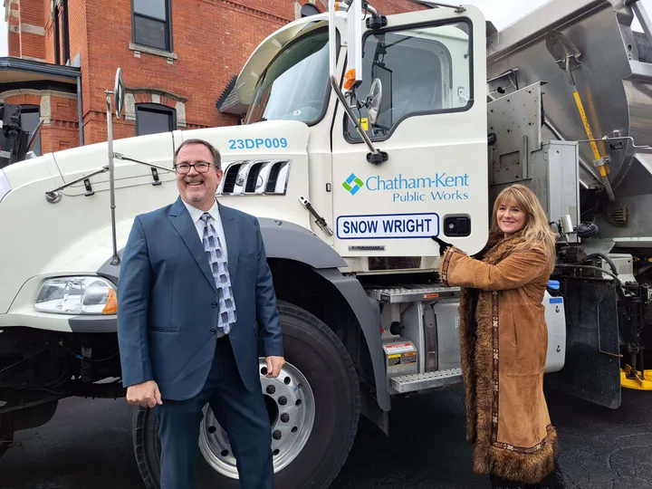 Chatham-Kent Public Works snowplow named Snow Wright with two people beside the truck.
